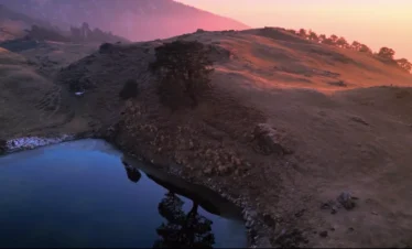 Brahmatal Lake sunrise view Uttarakhand, scenic alpine lake during Brahmatal Trek, Himalayan lake landscape India, Brahmatal winter trek mountain scenery, best Himalayan trekking destination