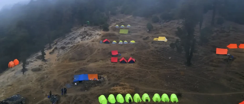 Brahmatal Trek campsite Uttarakhand, colorful tents on Brahmatal winter trek, Himalayan trekking camp India, Brahmatal Trek camping experience, best winter trek campsite in Uttarakhand