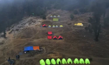 Brahmatal Trek campsite Uttarakhand, colorful tents on Brahmatal winter trek, Himalayan trekking camp India, Brahmatal Trek camping experience, best winter trek campsite in Uttarakhand