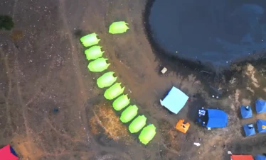 Brahmatal Trek lakeside campsite aerial view, Himalayan camping during Brahmatal winter trek, Brahmatal Trek tents near lake Uttarakhand, scenic trekking campsite India, best Himalayan trek camping experience