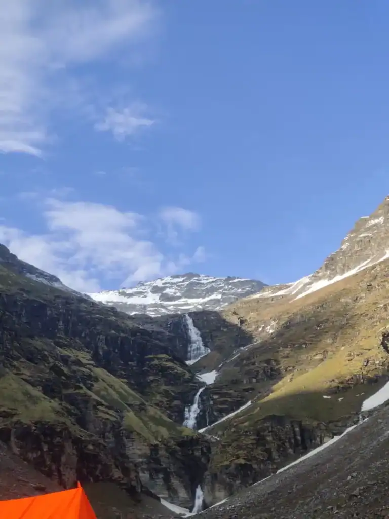 Scenic view of mountain waterfalls and snow-capped peaks during Rupin Pass Trek.