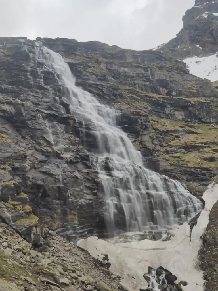 Scenic mountain waterfall during Rupin Pass Trek in the Himalayas.
